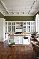 Fitted kitchen with chairs, drawers ,cabinets and wooden floor