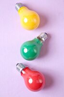 Red, yellow and green bulb on pink background