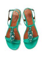 Green sandals decorated with beads on white background