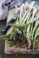 Close-up of green asparagus on wooden board