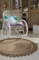 Mottled carpet with crocheted border from rope and white chair
