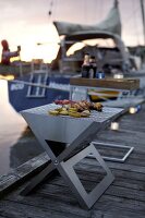 Stainless steel grill with food on footbridge