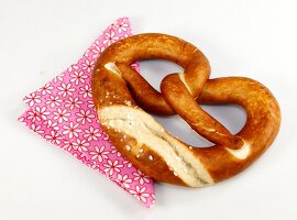 Pretzel cut at edge on floral patter napkin