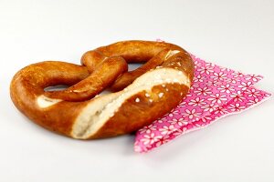 Pretzel cut at edge on floral patter napkin