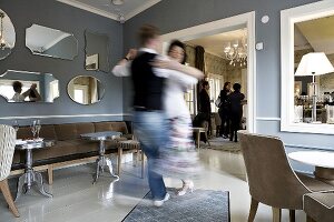 Couple dancing in a cafe ballroom, blurred motion, Finland