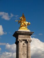 Statue at top of the column at Pont Alexandre III bridge, Paris, France
