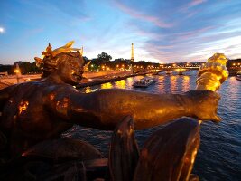 Pont Alexandre III over Seine river in night lights in Paris, France