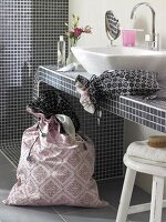 Pink and black fabric bag in bathroom with vanity sink