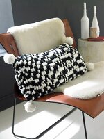 Black and white knitted cushion on chair