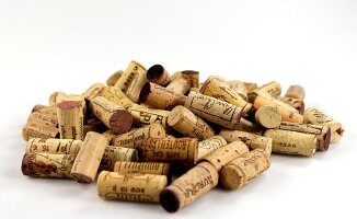 Several corks in pile on white background