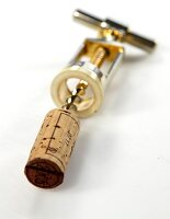 Cork with golden corkscrew on white background