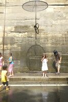Children playing in water, Paris, France