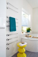 Bathroom with heated towel rail and yellow stool