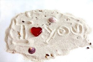 I Love You' written in sand on white background