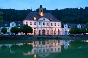 View of illuminated Landgrave Carl-channel at dusk in Bad Karlshafen, Hesse, Germany