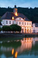 View of illuminated Landgrave Carl-channel at dusk in Bad Karlshafen, Hesse, Germany