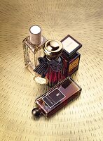 Close-up of different perfume bottles on brown floor