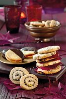 Poppy and pistachio snail cookies, chocolate and walnut cookies with vanilla jelly