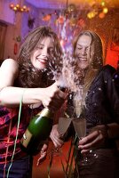 Two happy woman celebrating New Year with champagne