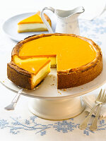 Holsteiner cheesecake on cake stand with one piece on spatula