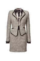 Tweed blazer, skirt with polka dotted shirt and necklace on white background