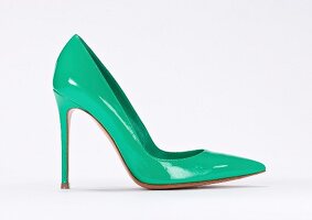 Close-up of turquoise stiletto pumps on white background