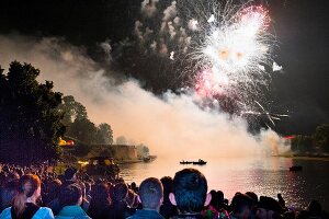 People watching fireworks in sky during midsummer festival in Krakow, Poland