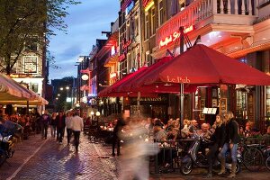 People at restaurants and bars in evening, Leidseplein, Amsterdam, Netherlands