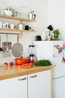 A work surface in a student kitchen with devices and utensils