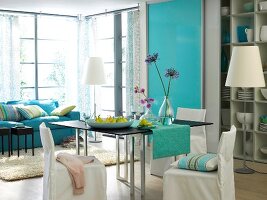 Living room and dining area in blue and turquoise shades