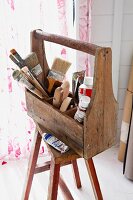 Various painting utensils in wooden toolbox