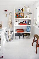 Painting utensils on wooden shelves in Scandinavian summer house