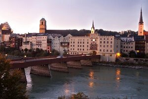 Woman walking on street in front of Wasserburg am Inn in Rosenheim, Bavaria, Germany