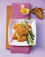 Veal escalopes with lemon sauce on square plate