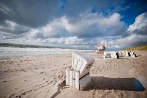 Hooded beach chairs on Westerland beach and Rotes Kliff in Sylt, Germany