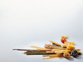 Variety of dried pasta on white background
