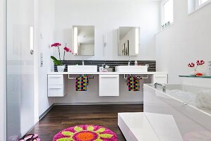 Vanity sink, cabinets and mirror in bathroom