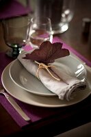 Plate decorated with linen napkin and leaves