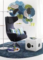 Armchair, cube shaped stools and floor lamp on grey carpet