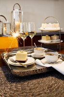 Champagne glasses, sparkler, cups of coffee and cake on tray for New Year's Eve