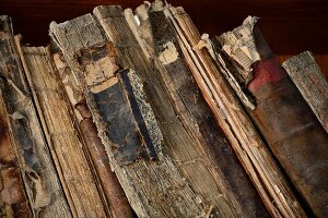 Close-up of old books arranged on shelf at Yosef Karo Synagogue Genizah, Safed, Israel