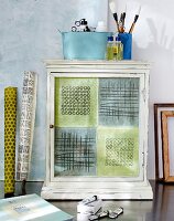 Old cupboard with patterned patchwork style and linen curtain by side