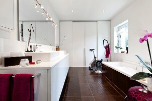 Vanity in bathroom with sink, tub and mirror