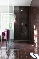 Spacious tiled large shower with glass wall