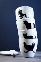 Tower from white cups with animal motifs