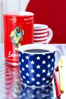 Close-up of cup with stars and stripes with coffee sleeve