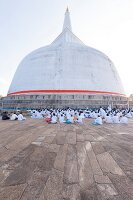 People praying at temple square Stupa of Mirisawetiya, Anuradhapura, Sri Lanka