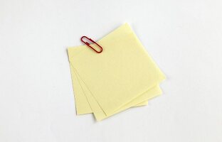 gelbe Notizzettel mit Büroklammer  X 