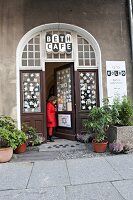 Woman coming out of Beth's cafe in Mitte, Berlin, Germany