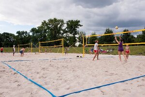 People playing beach volleyball at Friedrichshain Public Park in Berlin, Germany